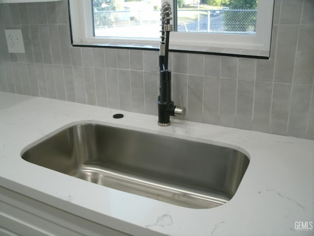 3111 Bucknell St, Bakersfield, CA 93305 - kitchen view of a sink, light stone counters, and white cabinets