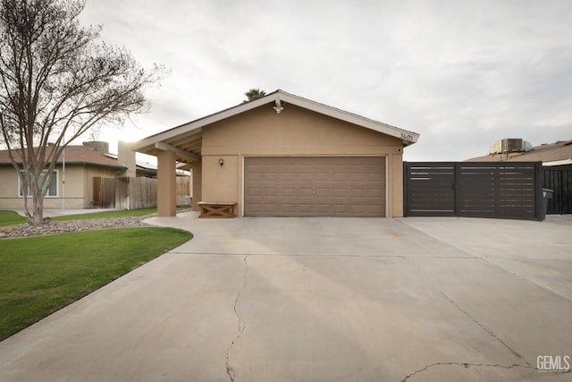 view of front of property with a garage, central AC, and a front lawn