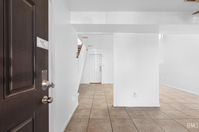 foyer entrance featuring light tile patterned floors