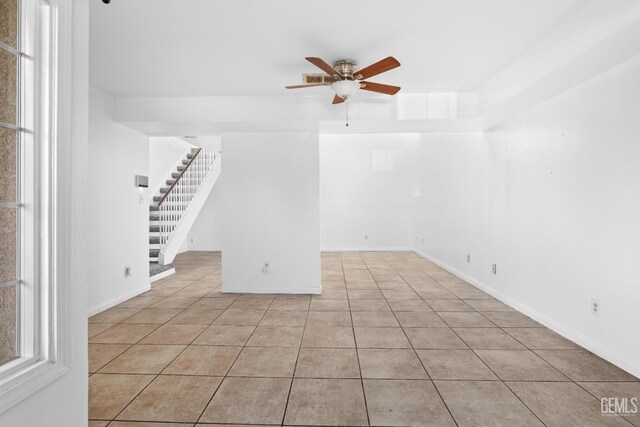 tiled empty room with ceiling fan