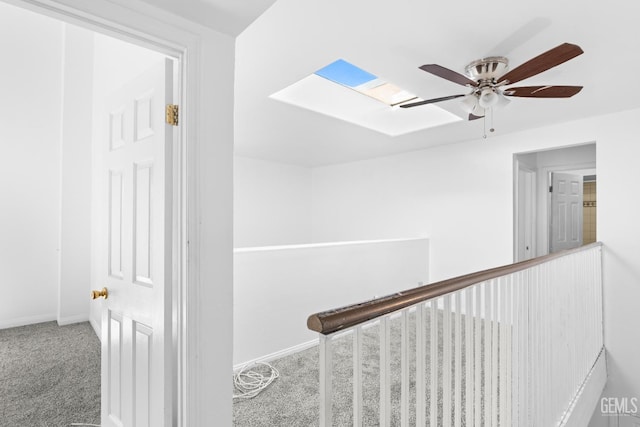 hall with carpet floors and a skylight