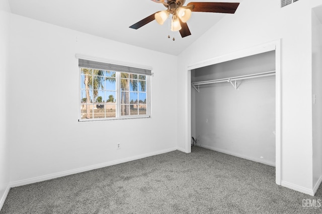 unfurnished bedroom with carpet flooring, a closet, vaulted ceiling, and ceiling fan