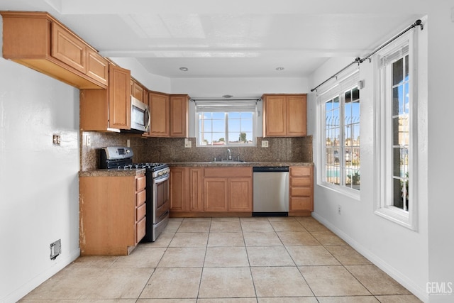 kitchen featuring light tile patterned flooring, stainless steel appliances, and tasteful backsplash