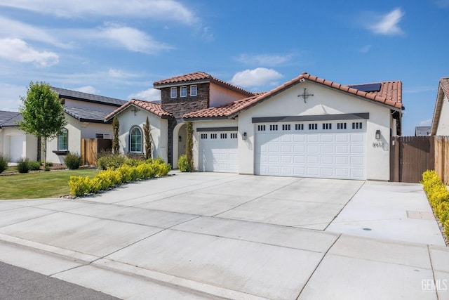 mediterranean / spanish-style home featuring stucco siding, driveway, an attached garage, and fence