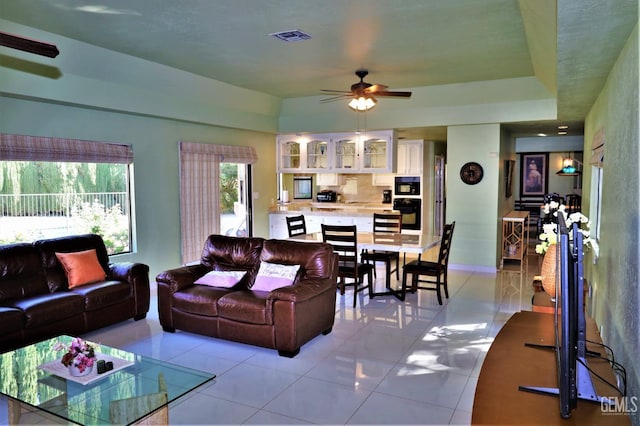 living room with ceiling fan and light tile patterned floors