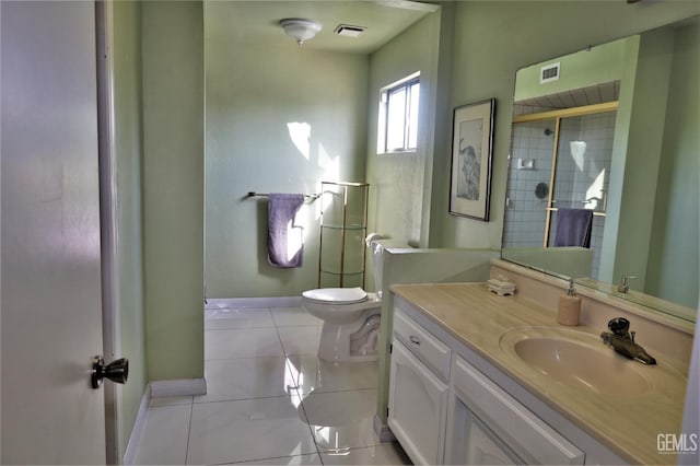 bathroom with toilet, vanity, walk in shower, and tile patterned flooring