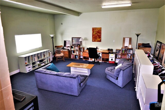 carpeted living room featuring beamed ceiling