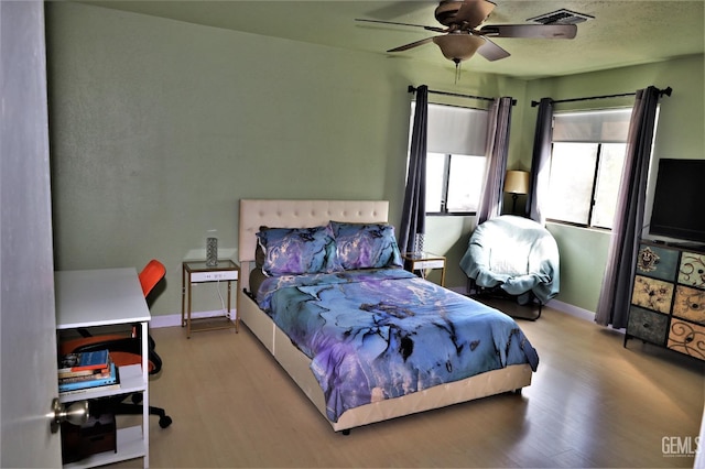 bedroom with light wood-type flooring and ceiling fan