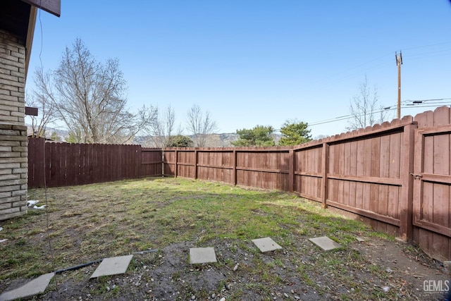 view of yard with a fenced backyard