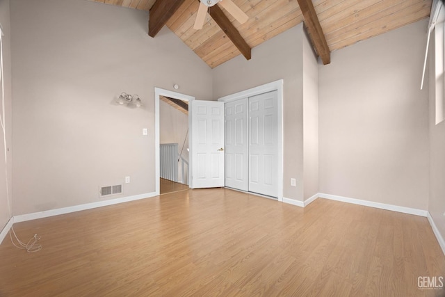 unfurnished bedroom with beam ceiling, visible vents, wood ceiling, wood finished floors, and baseboards