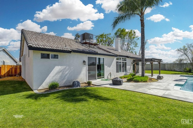 back of house with stucco siding, a lawn, a fenced backyard, a patio area, and a pergola