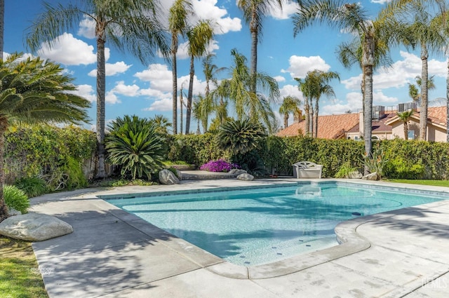 view of swimming pool featuring a patio, a fenced in pool, and fence