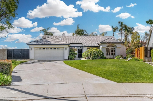 view of front of home featuring a front yard, fence, concrete driveway, a garage, and a tile roof