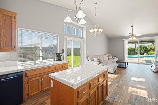 kitchen featuring dark wood-type flooring, open floor plan, black dishwasher, brown cabinets, and a sink