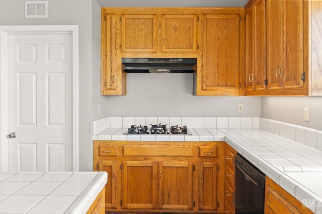 kitchen featuring brown cabinetry, visible vents, stainless steel gas cooktop, black dishwasher, and under cabinet range hood