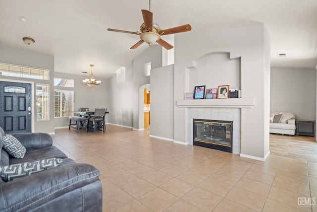 living room featuring tile patterned floors, a tile fireplace, and baseboards