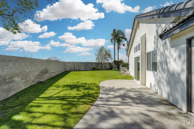 view of yard with a patio area and a fenced backyard