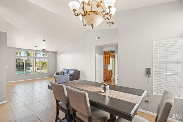 dining room with light tile patterned floors, visible vents, ceiling fan with notable chandelier, and vaulted ceiling