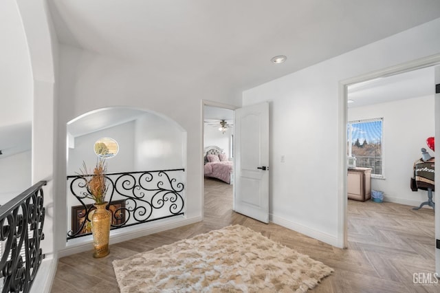 hall with baseboards and recessed lighting