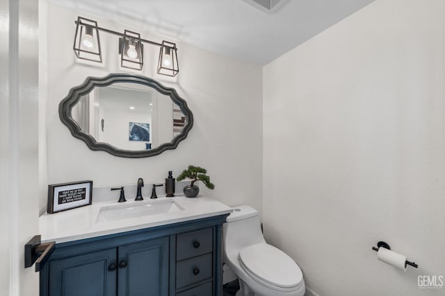 bathroom featuring vanity and toilet