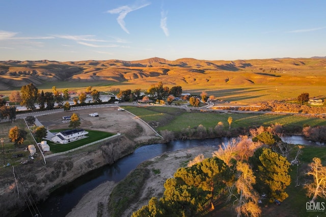 drone / aerial view with a water and mountain view