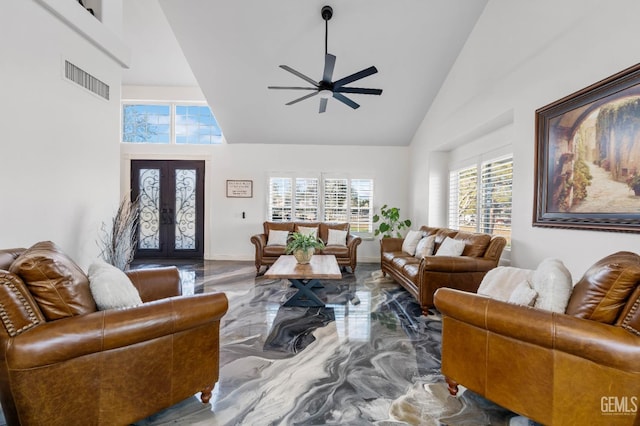 living area with high vaulted ceiling, a ceiling fan, marble finish floor, and visible vents