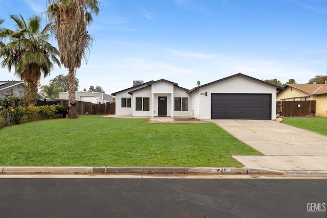 ranch-style house featuring a garage and a front lawn