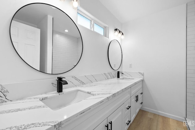 bathroom with hardwood / wood-style floors and vanity