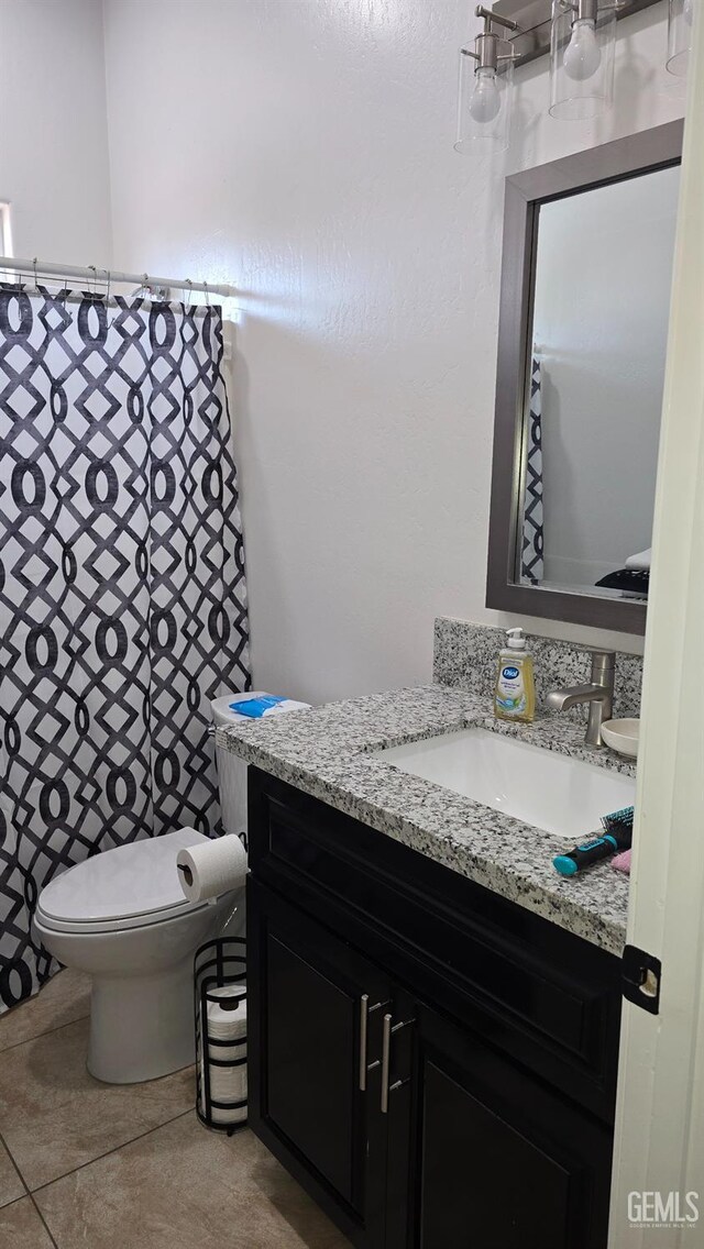 6304 Stanley St, Bakersfield, CA 93308 - bathroom featuring vanity, toilet, and tile patterned flooring