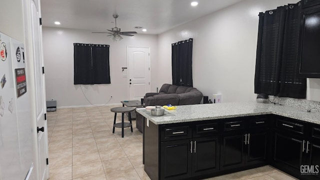 6304 Stanley St, Bakersfield, CA 93308 - kitchen with recessed lighting, dark cabinets, ceiling fan, a peninsula, and open floor plan