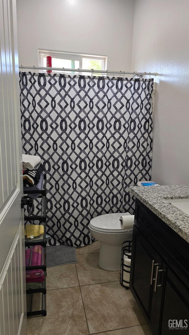 6304 Stanley St, Bakersfield, CA 93308 - bathroom featuring toilet, tile patterned flooring, and vanity