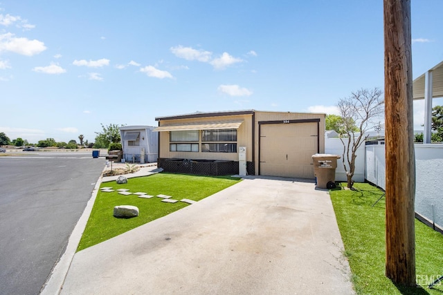 348 Petrol Rd Unit 394, Bakersfield, CA 93308 - view of front of house featuring concrete driveway and a garage