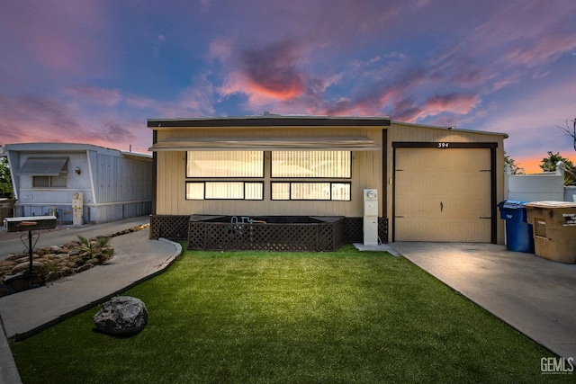 348 Petrol Rd Unit 394, Bakersfield, CA 93308 - view of front of home featuring concrete driveway, a front yard, and an attached garage