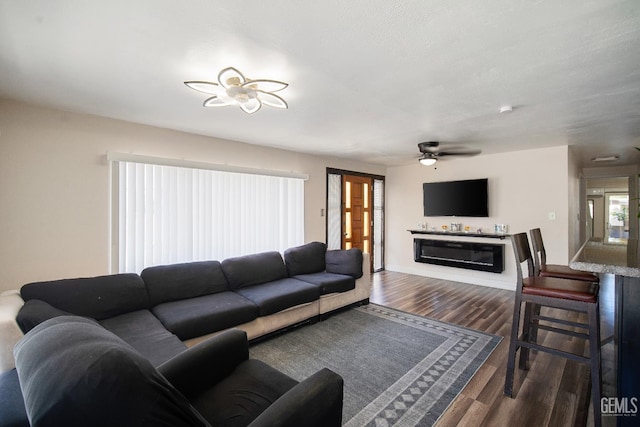 348 Petrol Rd Unit 394, Bakersfield, CA 93308 - living area with wood finished floors, a ceiling fan, and a glass covered fireplace