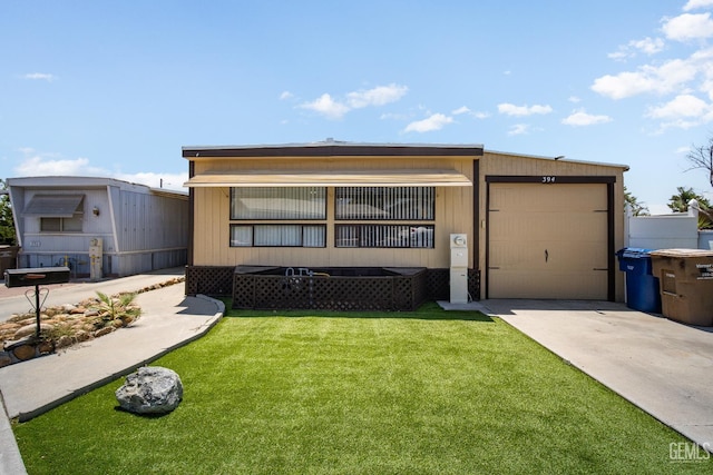 348 Petrol Rd Unit 394, Bakersfield, CA 93308 - manufactured / mobile home featuring concrete driveway, a front lawn, and an attached garage