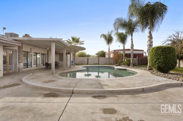 view of pool featuring a fenced backyard, a fenced in pool, a patio area, and french doors