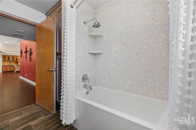bathroom with shower / bath combination and wood tiled floor