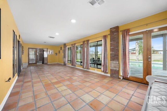 interior space with visible vents and french doors
