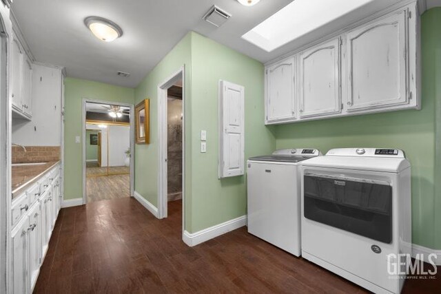 laundry area featuring separate washer and dryer, baseboards, visible vents, and dark wood finished floors