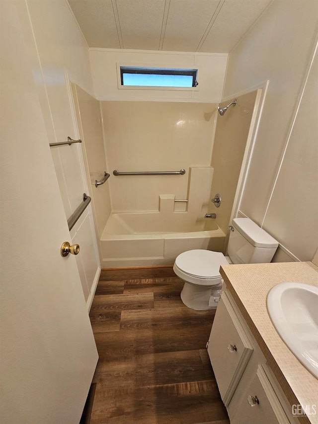 full bathroom featuring shower / washtub combination, vanity, wood-type flooring, and toilet