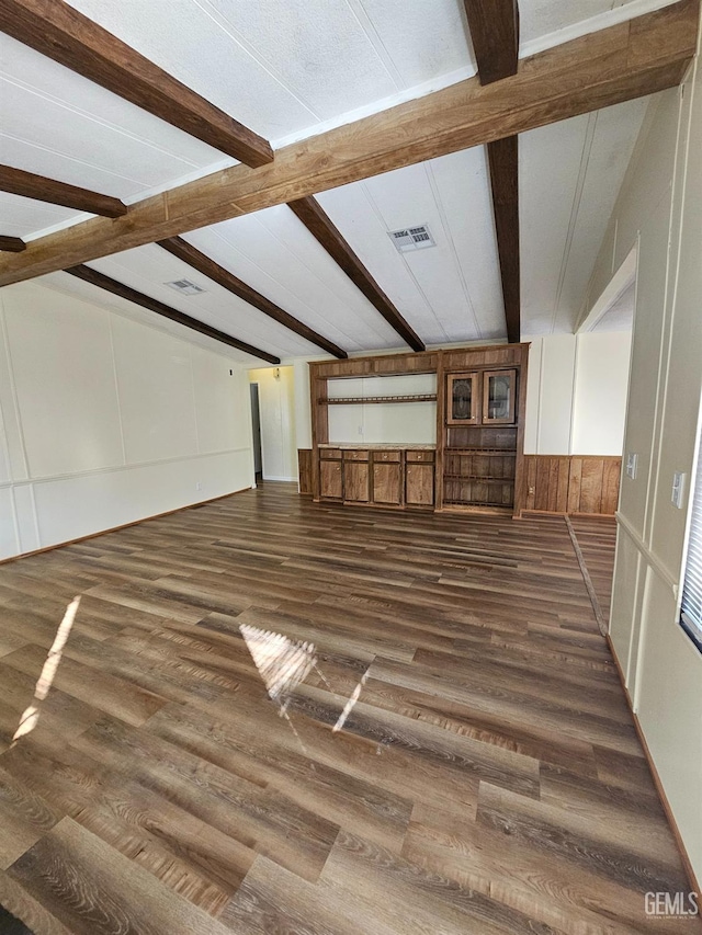 additional living space featuring dark hardwood / wood-style floors and beam ceiling