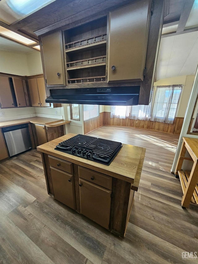 kitchen with wooden counters, stainless steel dishwasher, black gas stovetop, dark brown cabinets, and dark wood-type flooring