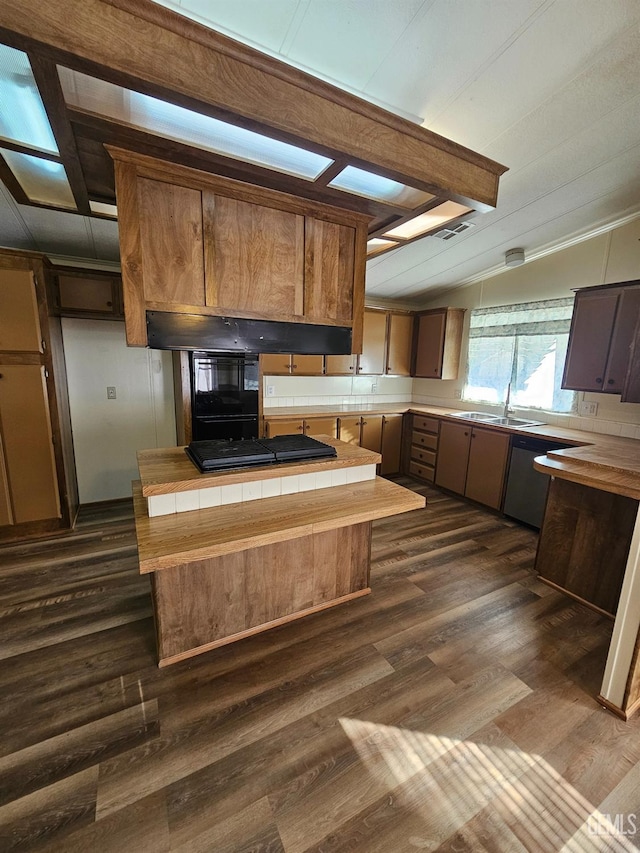 kitchen with vaulted ceiling with beams, tile countertops, gas stovetop, and dark wood-type flooring