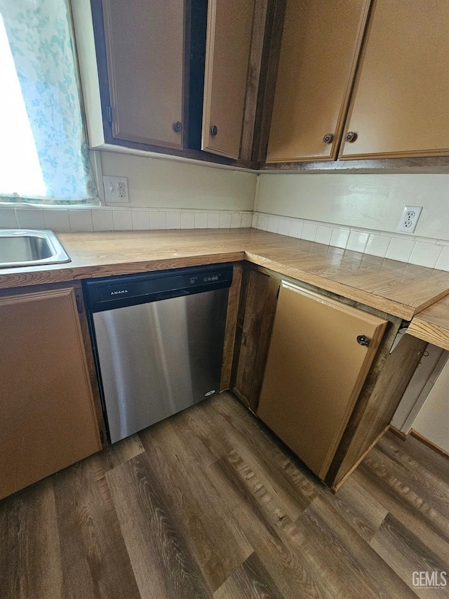 kitchen featuring sink, stainless steel dishwasher, dark hardwood / wood-style floors, and wood counters