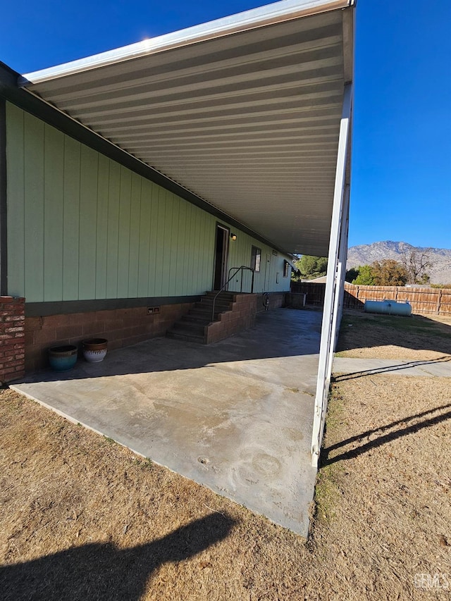 view of car parking featuring a mountain view and a carport