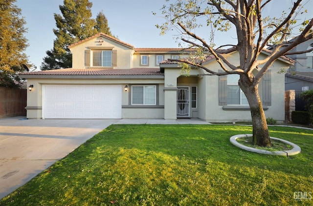 mediterranean / spanish-style home featuring a garage and a front yard