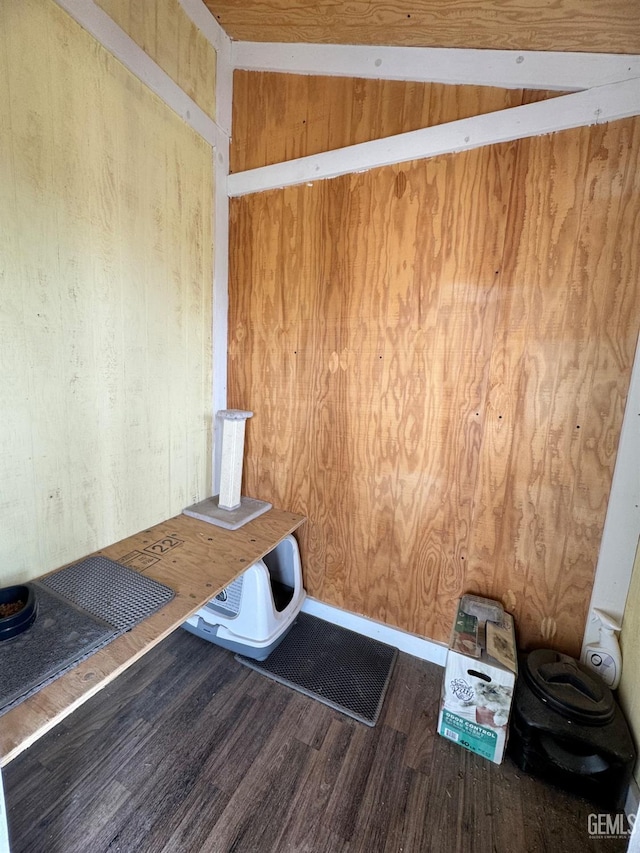 interior space featuring wood finished floors, wooden walls, and visible vents