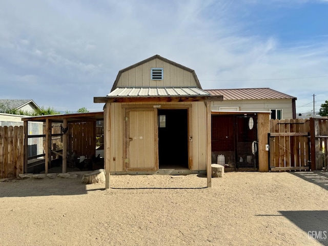 exterior space featuring fence, exterior structure, and an outbuilding