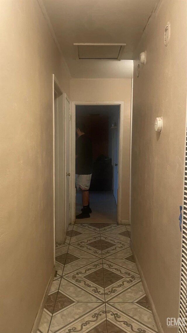 8300 Lexington Ave, Bakersfield, CA 93306 - hallway with attic access and light tile patterned flooring