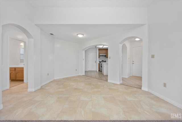 5820 Siena Ln, Bakersfield, CA 93308 - spare room featuring arched walkways and baseboards